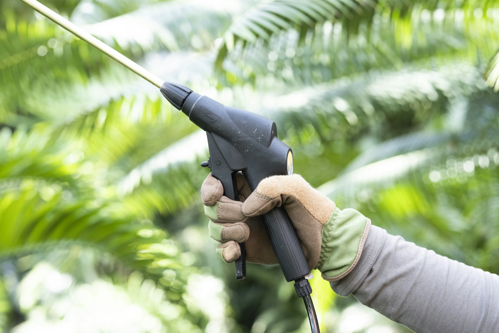 Landscaper spraying herbicide, illustrating Roundup settlement eligibility for a non-Hodgkin lymphoma claim